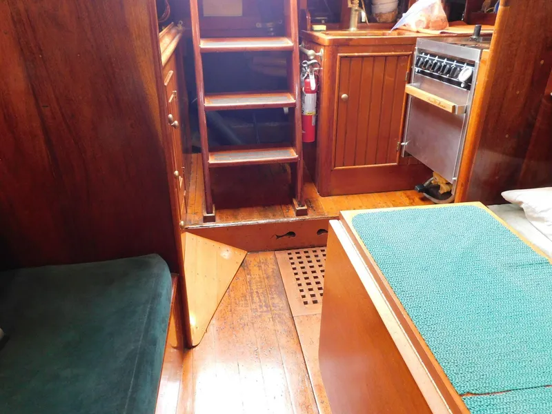 Slide: The Image of Interior of 1983 Custom Murray Peterson Coaster III boat with wooden furnishings and stairs. - 2
