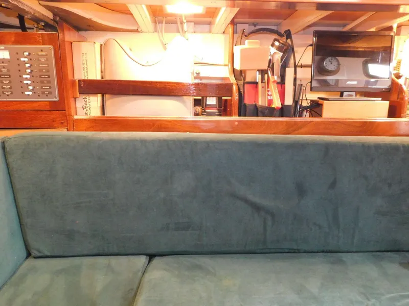 Slide: The Image of Interior of 1983 Custom Murray Peterson Coaster III with green sofa and wooden accents. - 4