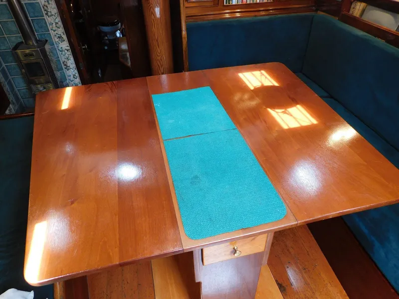 Slide: The Image of Wooden table with teal runner in a cozy boat interior, 1983 Murray Peterson Coaster III. - 5