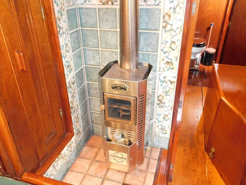Slide: The Image of Vintage Newport stove in a 1983 Custom Murray Peterson Coaster III boat interior. - 7