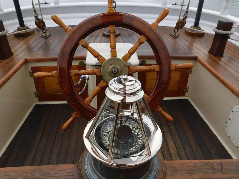 Slide: The Image of Wooden ship wheel and compass on 1983 Custom Murray Peterson Coaster III sailboat. - 9