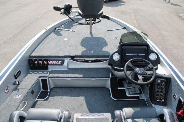 Slide: The Image of 2024 Phoenix 818 boat interior with steering wheel and Humminbird electronics. - 4