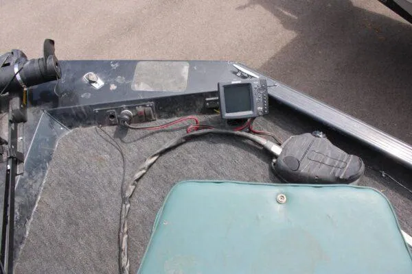 Slide: The Image of 1997 Xpress H56 boat interior with fish finder and trolling motor. - 4