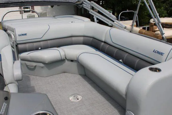 Slide: The Image of 2019 Lowe SS210 Super Sport boat interior with gray cushioned seating. - 3