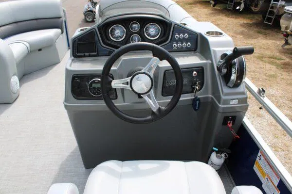Slide: The Image of 2019 Lowe SS210 Super Sport boat dashboard with steering wheel and control panel. - 4