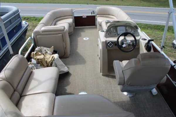 Slide: The Image of 2015 G3 X22 pontoon boat with beige seating and steering console. - 5