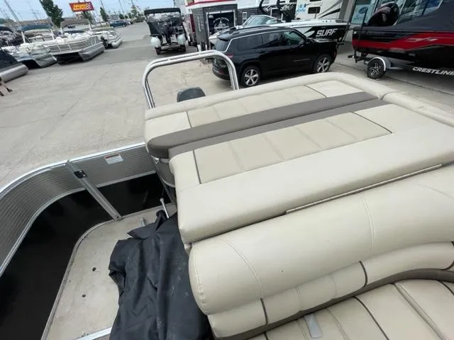 Slide: The Image of 2014 Starcraft Limited 236 pontoon boat with beige seating in a marina. - 11