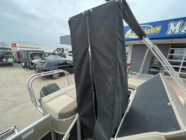 Slide: The Image of 2014 Starcraft Limited 236 pontoon boat at a dealership. - 12