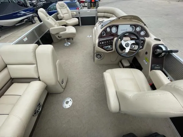Slide: The Image of 2014 Starcraft Limited 236 boat interior with beige seating and modern dashboard. - 13