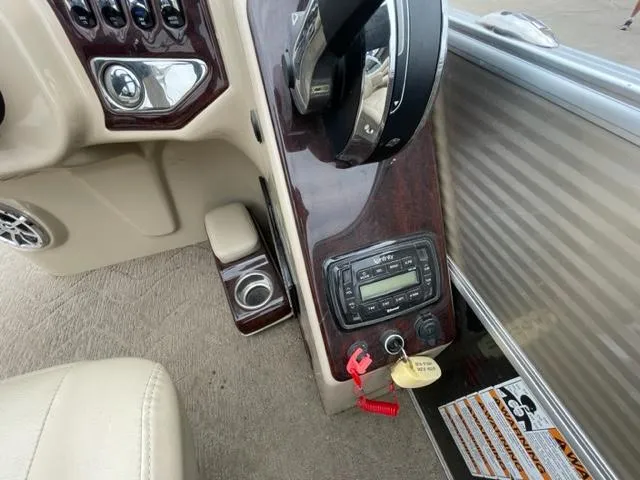 Slide: The Image of 2014 Starcraft Limited 236 boat dashboard with steering wheel and control panel. - 14