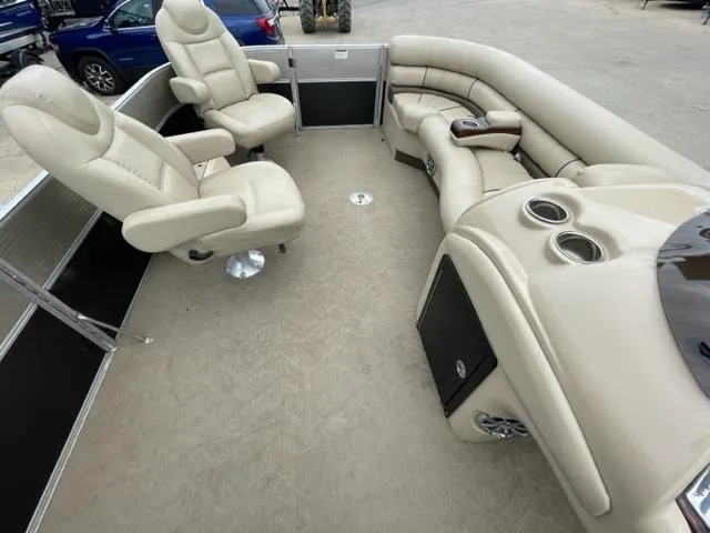 Slide: The Image of 2014 Starcraft Limited 236 boat interior with beige seating and cup holders. - 19
