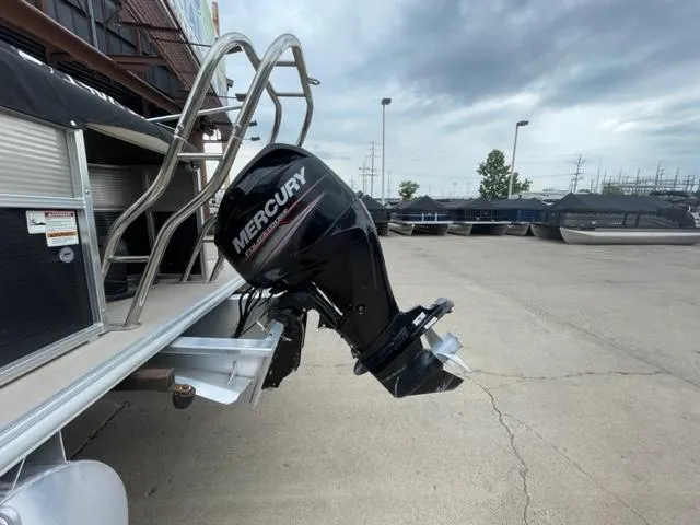 Slide: The Image of 2014 Starcraft Limited 236 with Mercury outboard motor in a marina. - 21