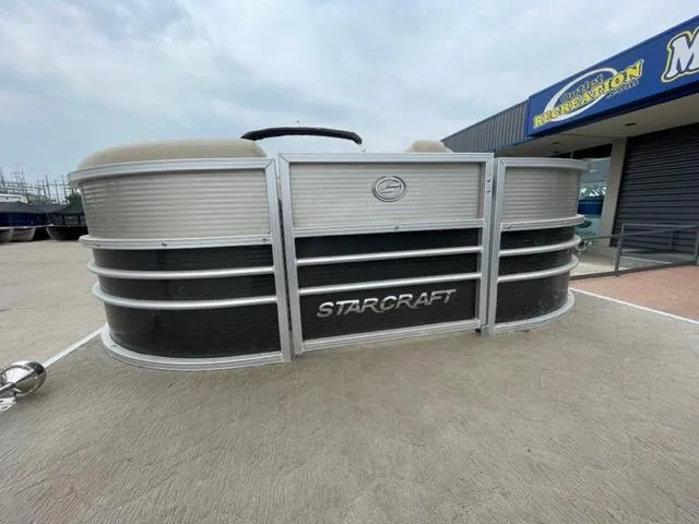 Slide: The Image of 2014 Starcraft Limited 236 pontoon boat displayed outside a dealership. - 4