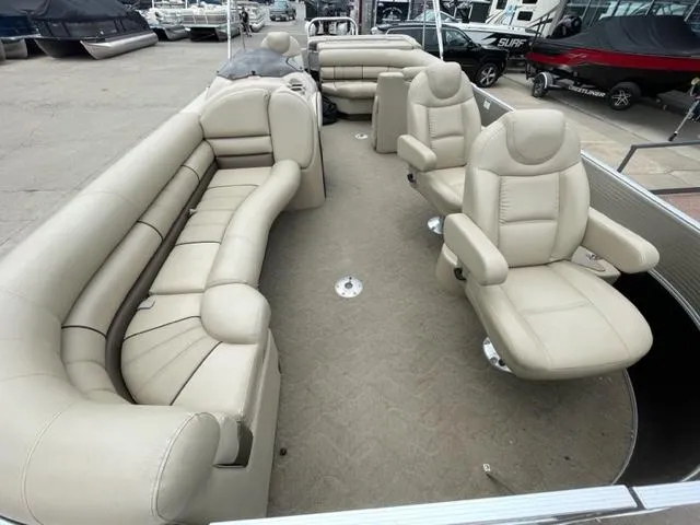 Slide: The Image of 2014 Starcraft Limited 236 pontoon boat with beige seating and spacious layout. - 5
