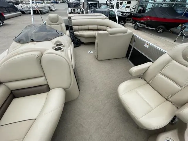 Slide: The Image of 2014 Starcraft Limited 236 pontoon boat with beige seating and spacious layout. - 8