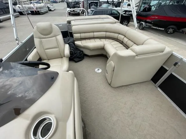 Slide: The Image of 2014 Starcraft Limited 236 pontoon boat interior with beige seating. - 9
