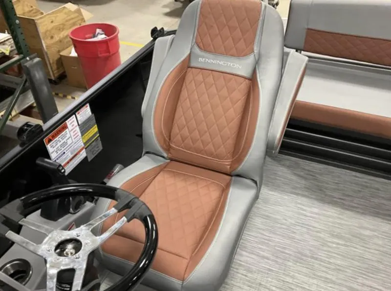 Slide: The Image of 2022 Bennington 23 LSB Swingback boat interior with tan and gray diamond-stitched seating. - 3