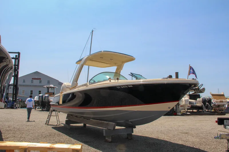 Slide: The Image of 2022 Chris-Craft Launch 25 GT boat displayed outdoors on a sunny day. - 1