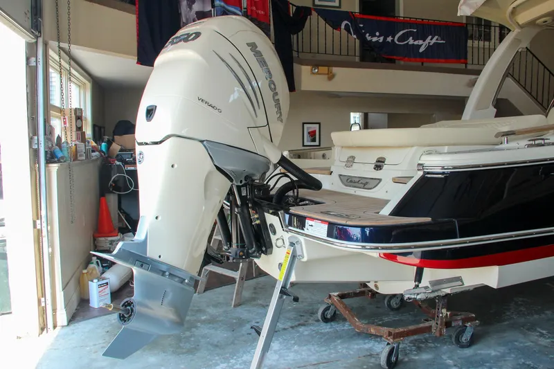 Slide: The Image of 2022 Chris-Craft Launch 25 GT boat with outboard motor in a showroom. - 10