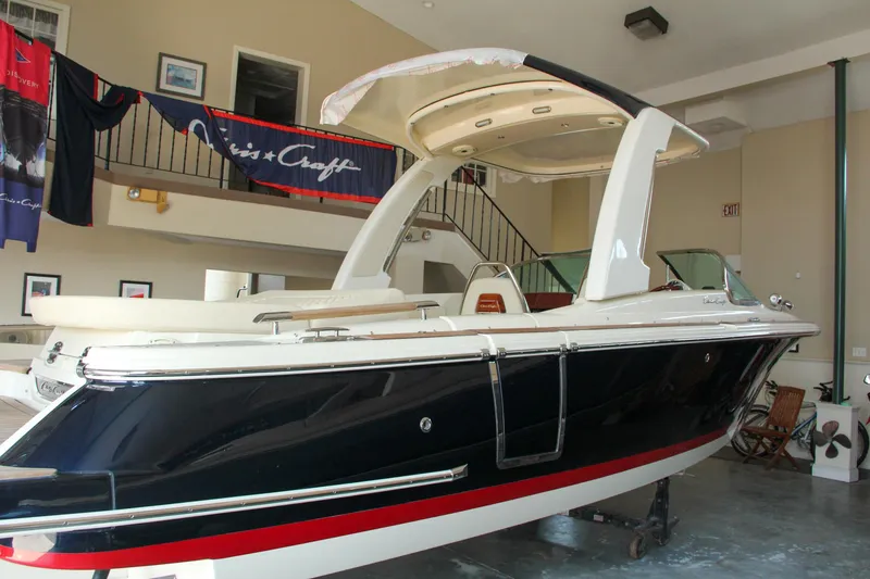 Slide: The Image of 2022 Chris-Craft Launch 25 GT boat displayed indoors, showcasing sleek design and luxury features. - 17
