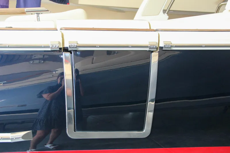 Slide: The Image of 2022 Chris-Craft Launch 25 GT boat side view with sleek design and reflective surface. - 18