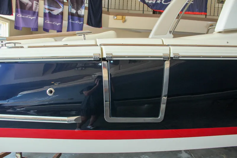 Slide: The Image of 2022 Chris-Craft Launch 25 GT boat side view with sleek design and chrome details. - 19