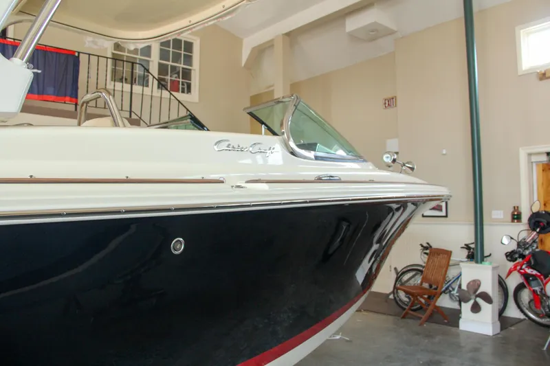 Slide: The Image of 2022 Chris-Craft Launch 25 GT boat in indoor showroom, side view. - 20