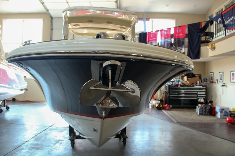 Slide: The Image of 2022 Chris-Craft Launch 25 GT boat in a garage, front view. - 21