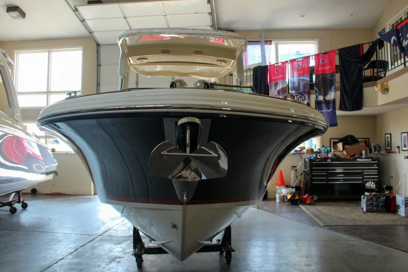 Slide: The Image of 2022 Chris-Craft Launch 25 GT boat in a garage, front view. - 22