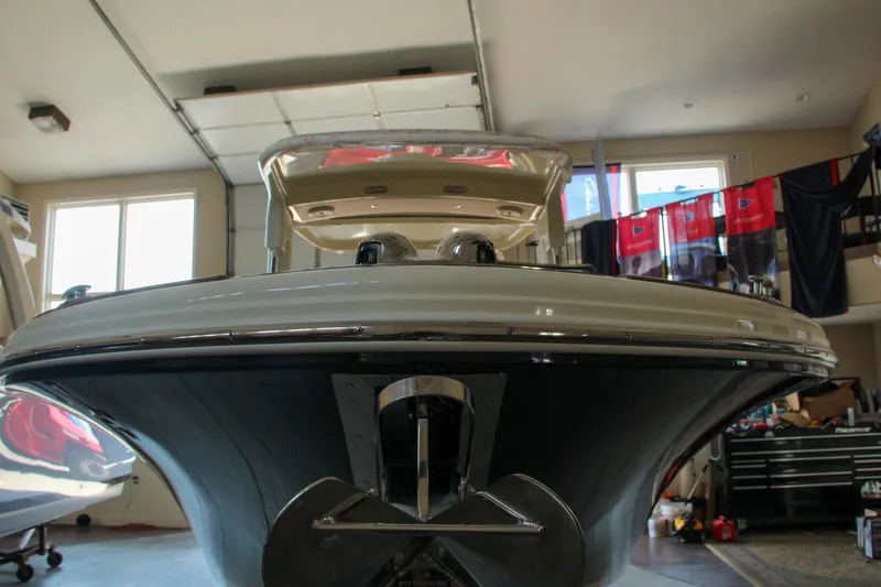 Slide: The Image of 2022 Chris-Craft Launch 25 GT boat in a garage, front view. - 23