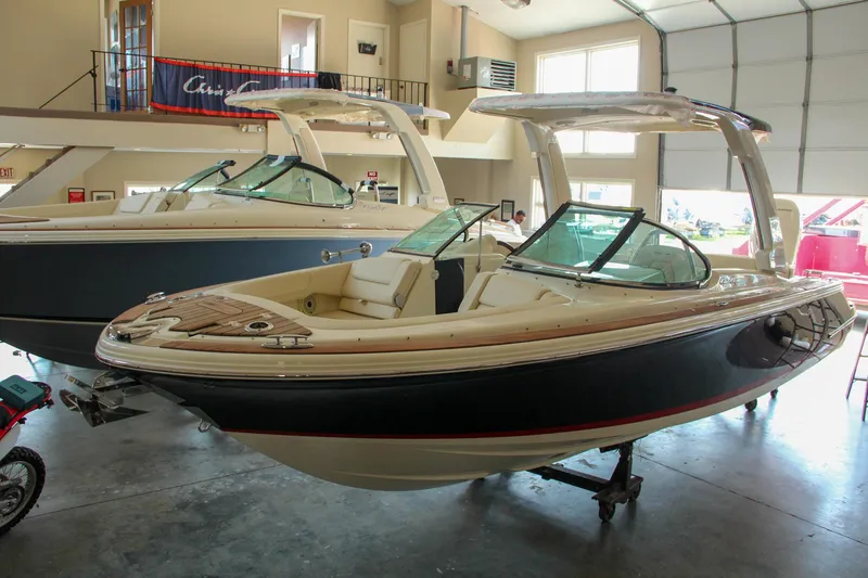 Slide: The Image of 2022 Chris-Craft Launch 25 GT boat displayed indoors, showcasing sleek design and luxury features. - 24