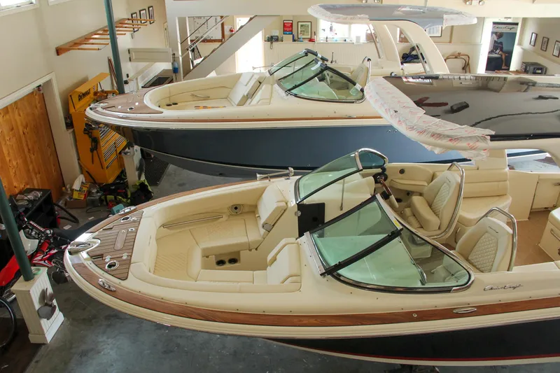 Slide: The Image of 2022 Chris-Craft Launch 25 GT boats in showroom, showcasing luxury design and craftsmanship. - 25