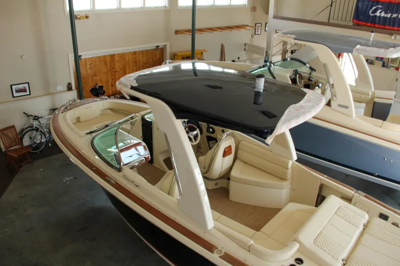 Slide: The Image of 2022 Chris-Craft Launch 25 GT boat in showroom, featuring sleek design and luxurious interior. - 27