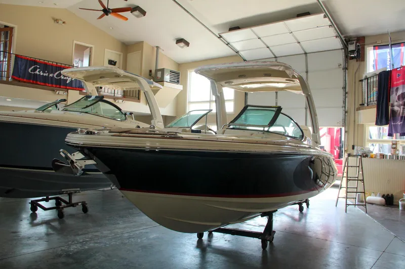 Slide: The Image of 2022 Chris-Craft Launch 25 GT boat in a showroom, showcasing sleek design and luxury features. - 29