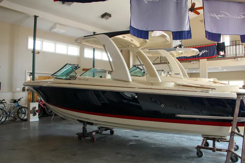 Slide: The Image of 2022 Chris-Craft Launch 25 GT boat displayed indoors, showcasing sleek design and luxury features. - 31