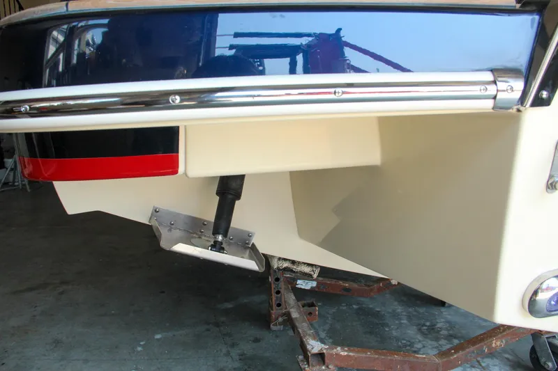 Slide: The Image of 2022 Chris-Craft Launch 25 GT boat stern view in a garage setting. - 32