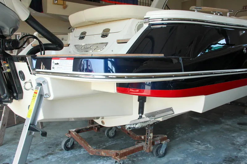 Slide: The Image of 2022 Chris-Craft Launch 25 GT boat rear view in a garage setting. - 33