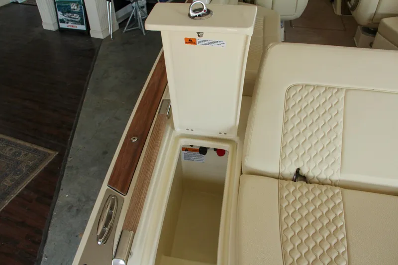 Slide: The Image of 2022 Chris-Craft Launch 25 GT interior with beige quilted seating and storage compartment. - 37