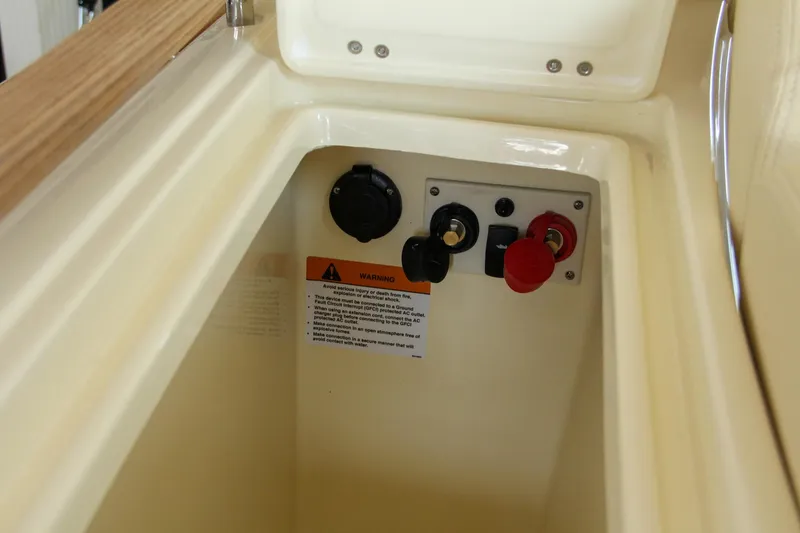 Slide: The Image of 2022 Chris-Craft Launch 25 GT control panel with warning label and switches. - 38