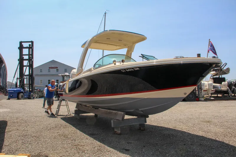Slide: The Image of 2022 Chris-Craft Launch 25 GT boat on display in a marina setting. - 4