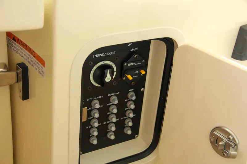 Slide: The Image of 2022 Chris-Craft Launch 25 GT control panel with switches and dials. - 44