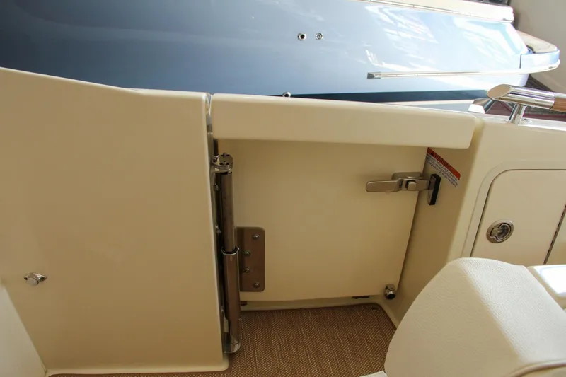 Slide: The Image of 2022 Chris-Craft Launch 25 GT boat interior, featuring a sleek door and polished hardware. - 45
