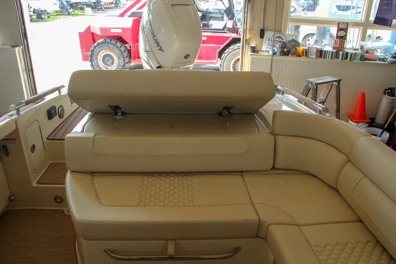 Slide: The Image of 2022 Chris-Craft Launch 25 GT interior with beige leather seating and storage compartment. - 46