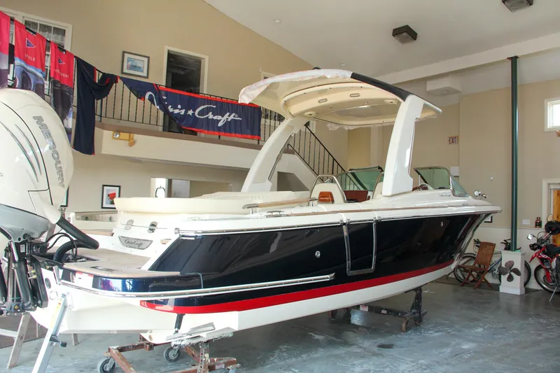 Slide: The Image of 2022 Chris-Craft Launch 25 GT boat displayed indoors, showcasing sleek design and modern features. - 6