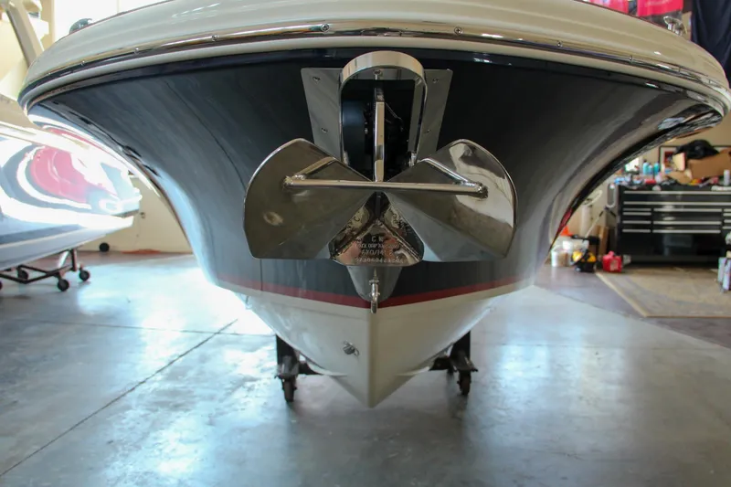 Slide: The Image of 2022 Chris-Craft Launch 25 GT boat in a garage, showcasing its sleek bow design. - 9