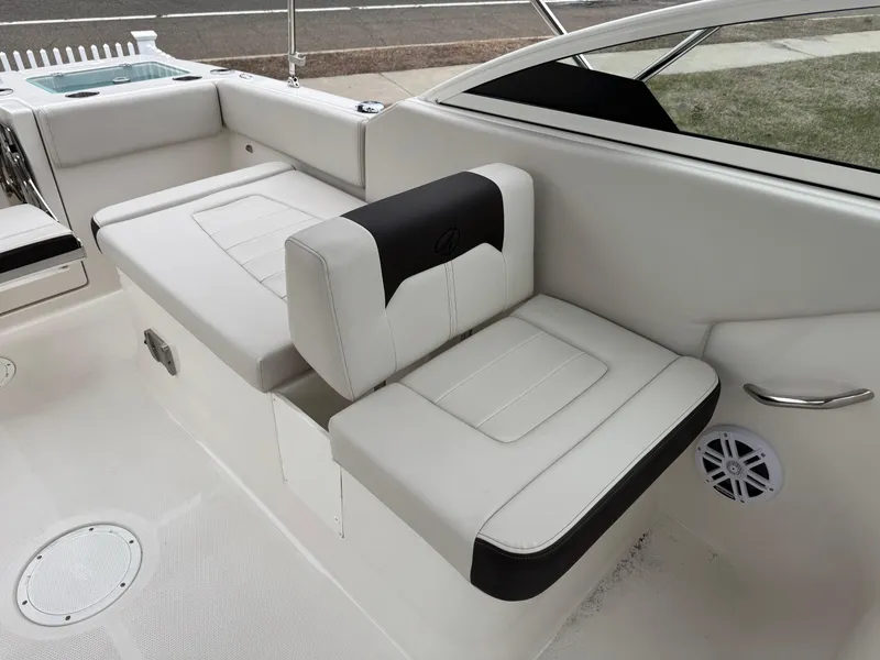 Slide: The Image of 2024 Sailfish 226 boat interior with white cushioned seating and modern design. - 10