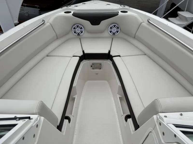 Slide: The Image of 2024 Sailfish 226 boat interior with white seating and speakers. - 2