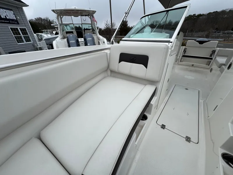 Slide: The Image of 2024 Sailfish 226 boat interior with white cushioned seating and sleek design. - 3