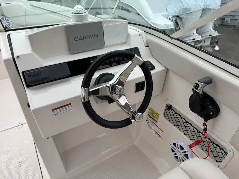 Slide: The Image of 2024 Sailfish 226 boat helm with Garmin navigation and steering wheel. - 5