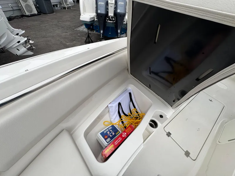 Slide: The Image of 2024 Sailfish 226 boat storage compartment with safety equipment and accessories. - 6